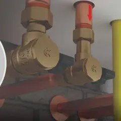 System hydrauliczny z mosiężnymi elementami, w tym zawór zwrotny klapowy, miedziane rury i żółta rura.