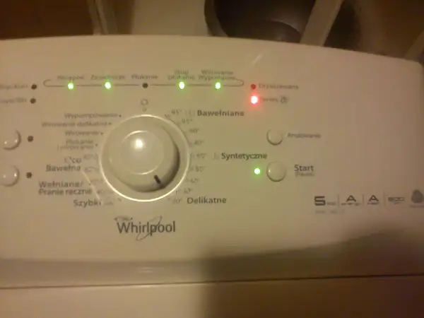 Panel sterowania pralki Whirlpool z oznaczeniami symboli programów: Bawełniane, Syntetyczne, Delikatne.